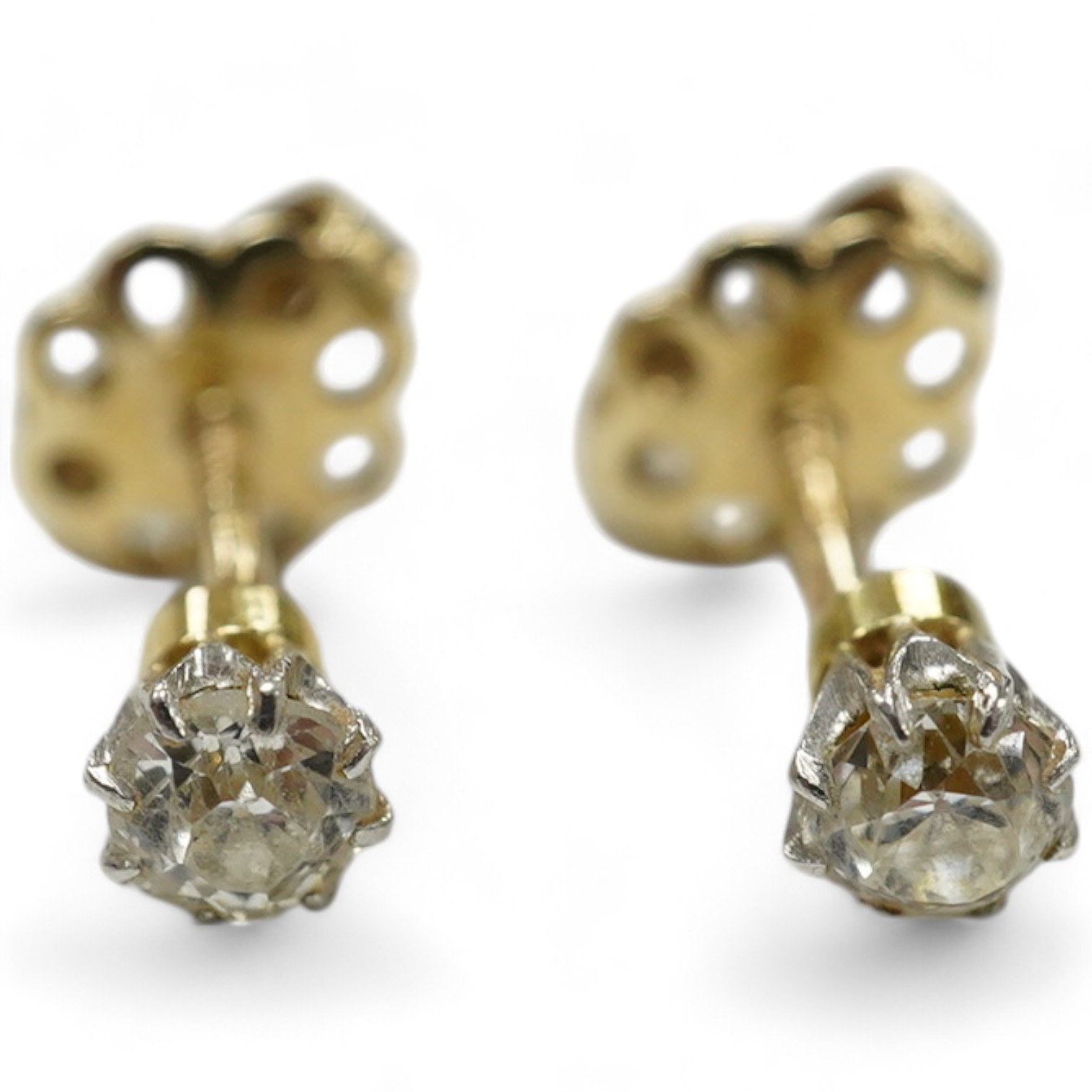 A pair of yellow metal and solitaire diamond set ear studs, gross weight 1 gram. Condition - fair to good